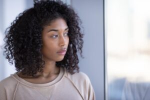 a woman pensively stares afar thinking about how do veins collapse from iv drug use