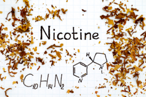 tobacco on a piece of paper with nicotine and chemical compound name written after someone asks the question is nicotine a depressant