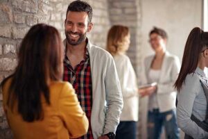 a man smiling while talking to a woman about rehab admissions