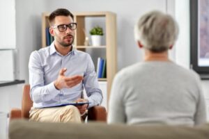 a male therapist talks to an adult woman patient during her personality disorder treatment program