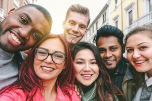 a group of people smile for a photo together while at their lgbtq-friendly rehab center