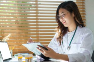 a medical professional sits at desk with clipboard reading about when to get on methadone and how it helps patients